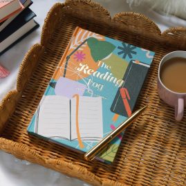 Reading log in a basket with a cup of tea