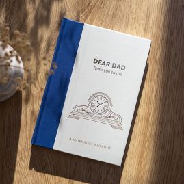 Dear Dad front cover on wooden table.