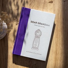 Dear Grandma memory journal on wooden table. 