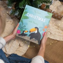 My First Christmas Personalised Children's Book, in minimalist festive setting.