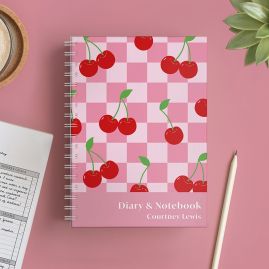 Personalised Cherry Diary and Planner front on pink table.