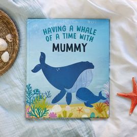 Having a whale of a time with mummy hardback book on white cloth with star fish