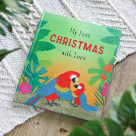 My First Christmas With . . . hardback book on a  rug on a wooden background